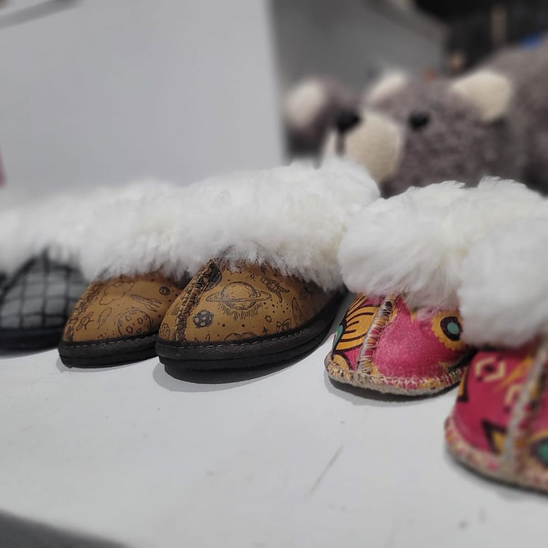 Warm sheepskin slippers with space designs for children.