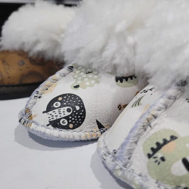 Animal-themed sheepskin slippers for babies.