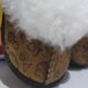 Sheepskin slippers with space-themed designs for babies.