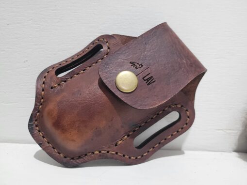 Leather paddle pouch for Leatherman tools with snap closure.